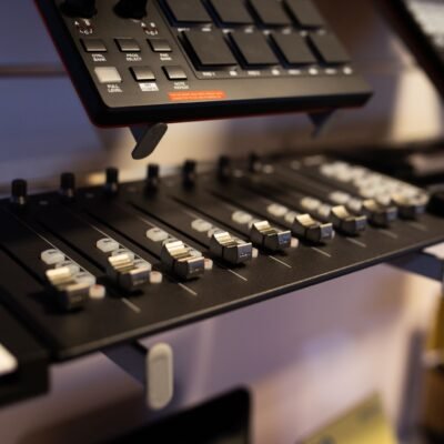 A close-up view of professional audio mixing equipment in a studio setting.