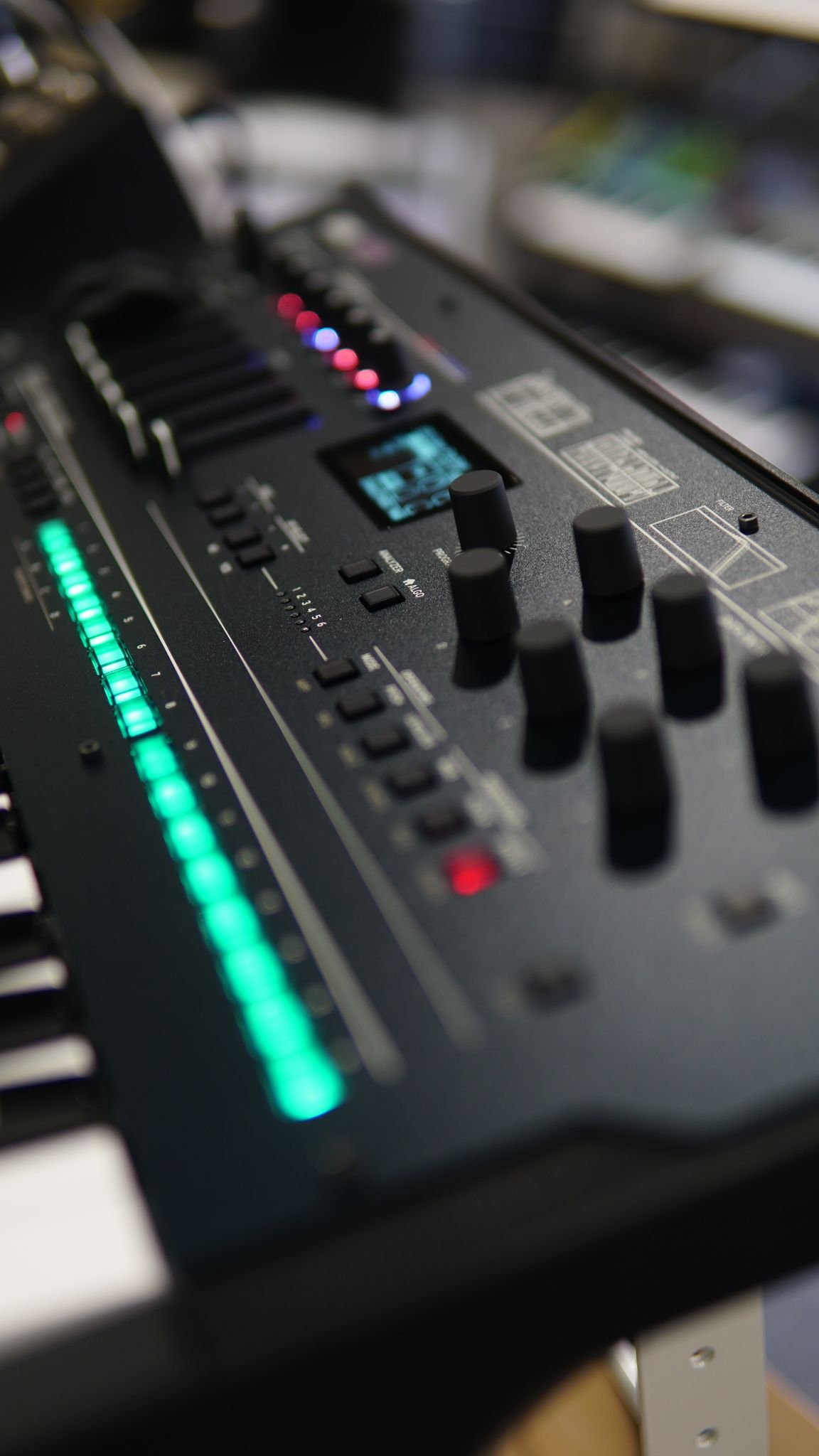 Close-up of a professional audio mixer with LED indicators and control knobs, showcasing musical technology.