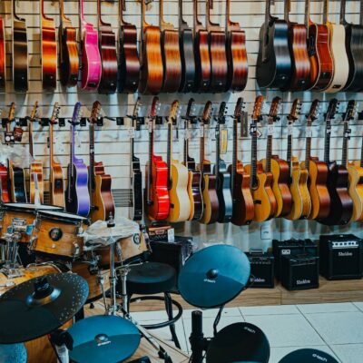 Vibrant display of guitars and drums in a music store, showcasing a variety of instruments.